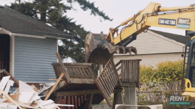 excavator tears down a house