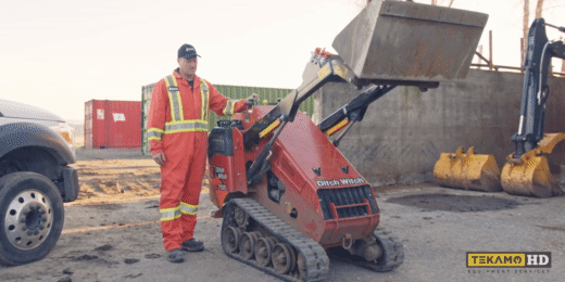 heavy mechanic operates a Ditch Witch mini skid steer to lift its hydraulic arms up