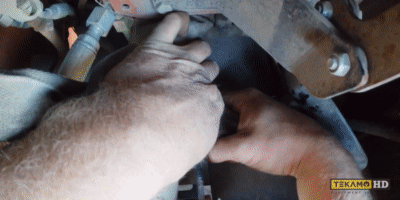 HD mechanic removes fuel filter from inside a Ditch Witch mini skid steer