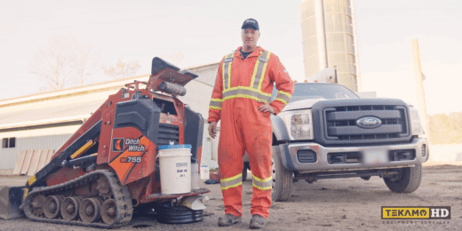 Mechanic pouring Tekamo oil into a Ditch Witch SK755