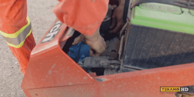 Mechanic removes the oil filter on mini skid steer