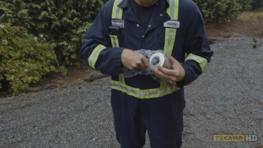Heavy duty mechanic inspects a hydraulic return filter for a mini excavator