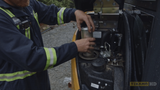 HD mechanic demonstrates the installation of hydraulic oil filter in a mini excavator