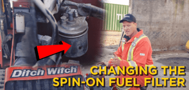 HD mechanic next to a close up of the inside of a Ditch Witch with an arrow pointing to the spin-on fuel filter