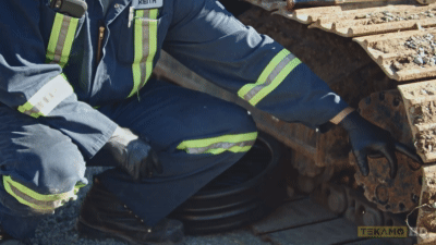 heavy duty technician shows where to align final drive plugs on an excavator