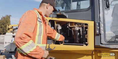 Gif of a pro-mechanic removing the first hydraulic filter on a John Deere dozer