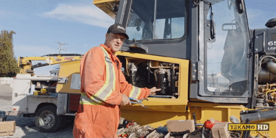 Gif of a pro-mechanic removing the second filter on a John Deere dozer