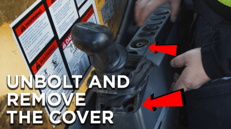 HD-mechanic-removing-the-console-cover-in-an-excavator-470x264