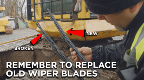 Heavy-duty-mechanic-replacing-old-wiper-blades-on-an-excavator-470x264